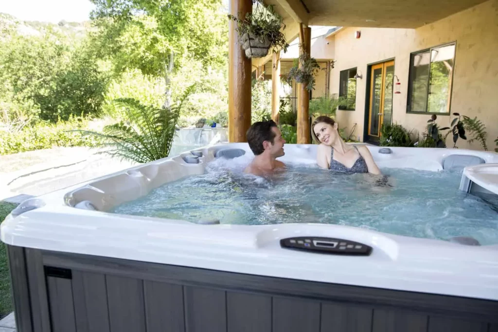 Sundance® Difference - Sunspa - Hot Tubs, Swim Spas &Amp; Service In Calgary A Young Couple Relaxing In The Hot Tub After Work